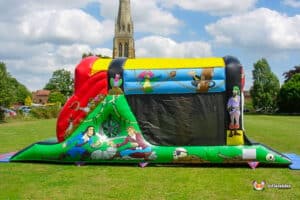 A colourful pirate-themed fun run sits on a grassy field, featuring cartoon characters and fun pirate imagery under a bright sky.