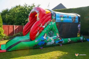 A colourful inflatable pirate themed fun run in a sunny backyard, featuring cartoon characters and vibrant designs.