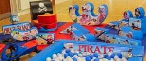 A vibrant pirate-themed soft play area featuring colorful toys and games for children to enjoy.