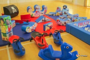 A playful pirate-themed area with soft toys and climbing structures, inviting children to engage in imaginative adventures.