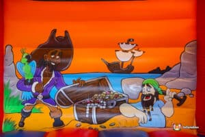 A lively bouncy castle in a pirate theme, depicting a pirate alongside his crew, ideal for children's parties.