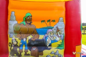 A vibrant bouncy castle adorned with cheerful cartoon characters, perfect for children's entertainment and enjoyment.