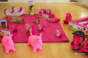 A whimsical pink play area showcasing pink toys and a charming pink horse, designed for imaginative playtime fun.