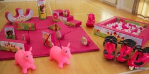 A delightful pink play area with an array of pink toys and a playful pink horse, inviting children to explore and play.