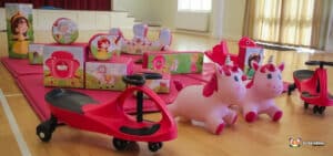 A cheerful pink play area adorned with pink toys and a friendly pink horse, creating a magical space for young children.