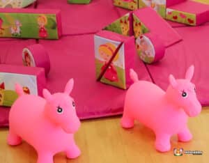 A vibrant pink play set showcasing a princess and her horse, perfect for creative storytelling and playtime.