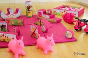 A lovely pink play area featuring pink toys and a playful pink horse, designed for fun and creativity in a princess theme.