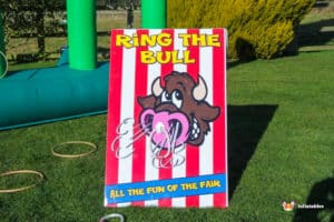 A sign displaying the words "Ring The Bull" in bold letters, inviting participation in a fun activity.