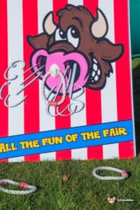 A playful sign saying "Ring The Bull," inviting visitors to join in on the fun.