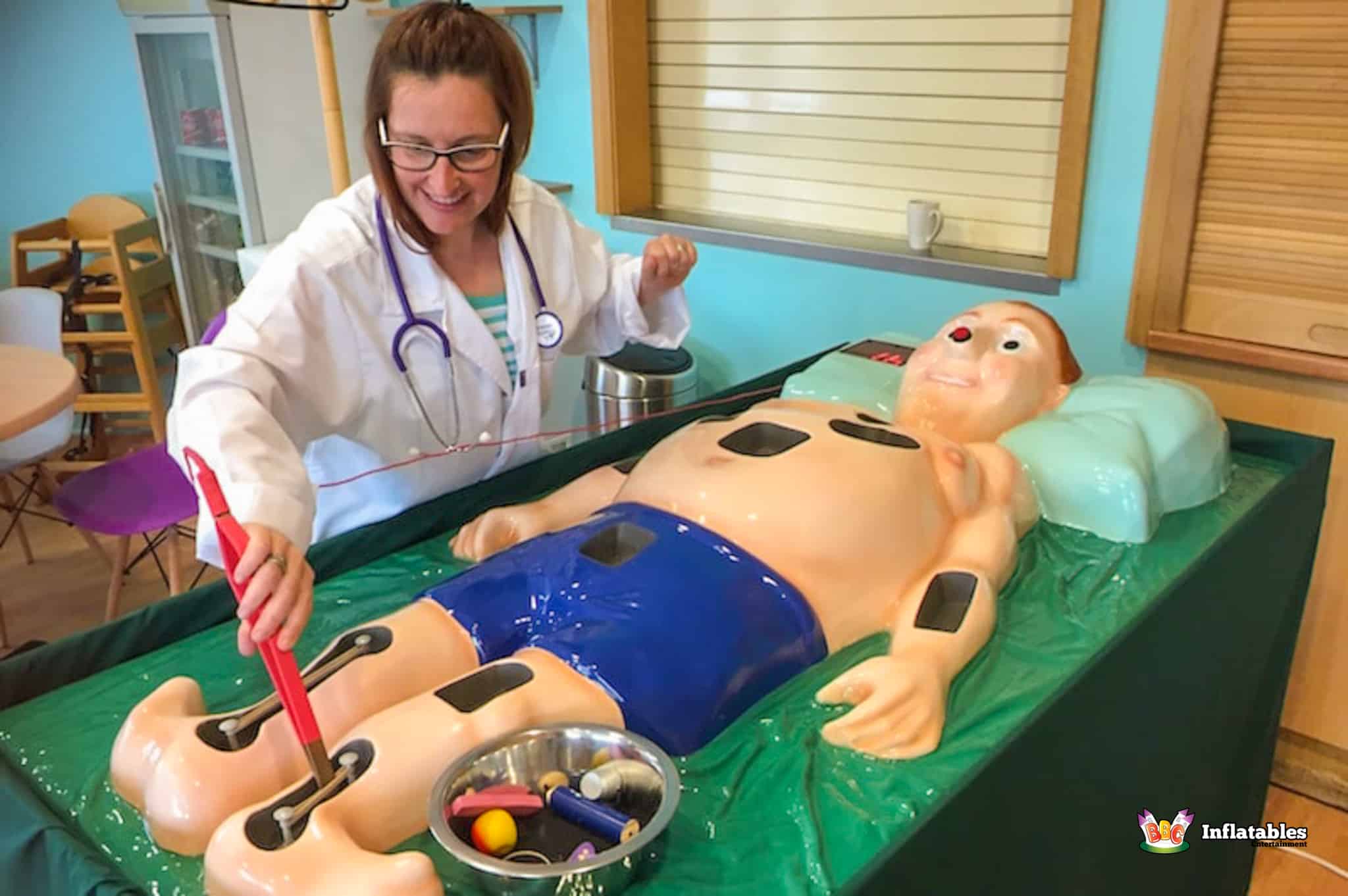A woman in a white lab coat performs surgery on a man in the Sawbones Electronic Operation Game.