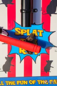 A red and white striped sign showcasing a mouse to hit.