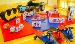 Colorful play area featuring toys and a small car, designed for children at Superhero Soft Play.