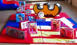 Engaging play area with various toys and a car, perfect for fun and adventure at Superhero Soft Play.