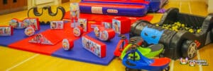 Vibrant play area with toys and a car, designed for children's enjoyment at Superhero Soft Play.
