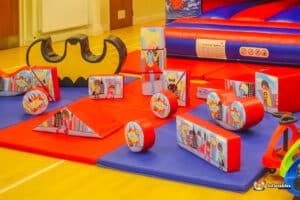 A vibrant play area featuring colorful toys and a small car, designed for children at Superhero Soft Play.