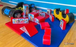 A lively children's play area at Superhero Soft Play, showcasing various toys and a toy car for imaginative play.