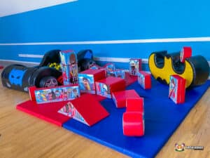 A playful scene at Superhero Soft Play, with an assortment of toys and a small car in a colorful play area for kids.