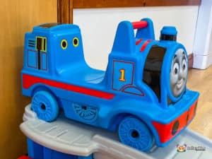 A vibrant Thomas the Tank Engine slide located in a hall, designed for children's play and entertainment.