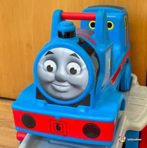 A cheerful Thomas the Tank Engine slide in a hall, ready for children to climb and slide down for fun.