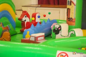 Child's inflatable play area designed for toddlers, including a bright car and a whimsical sheep.