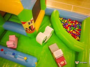 Inflatable toddler play zone featuring various toys and balls, creating a fun and safe environment for young children.