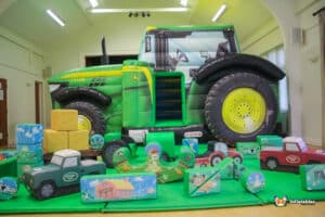 Inflatable tractor featuring toys and a play area, included in the Tractor B&S Deluxe Package for kids' fun and play.