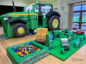 A large inflatable tractor with soft play shapes and a play area, designed for children.