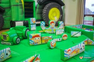 Play area featuring the Tractor Bounce & Slide Soft Play Package with colorful toys and a large inflatable tractor.