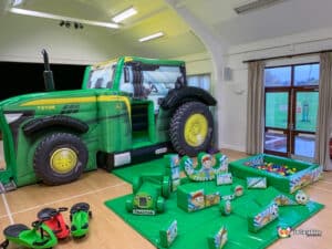 Children's play area with a tractor and assorted toys, included in the Tractor Bounce & Slide Soft Play Package.
