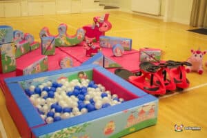 A lively play area filled with toys, a fun ball pit, and a charming unicorn figure adding magic to the scene.