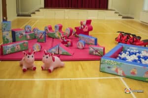Colorful play area featuring various toys, a vibrant ball pit, and a whimsical unicorn decoration.