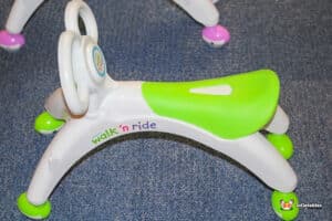 A playful toy car with functional wheels and a seat, designed for walking and riding fun for kids.