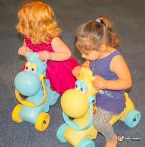 children playing on push along cars.