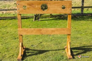 A wooden pillory stand featuring a central hole, designed for holding individuals during punishment