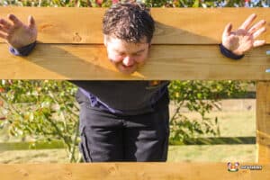 A wooden pillory structure with a circular hole, typically used for public punishment or display.