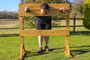 A wooden stand resembling a pillory, with a prominent hole in the center for restraint purposes.
