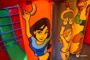 A large inflatable slide featuring cartoon characters, part of set in a vibrant outdoor area.