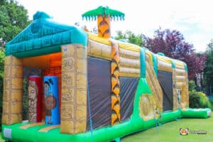 Inflatable jungle-themed bouncer at Aztec Fun Run 1, featuring vibrant colors and playful animal designs.