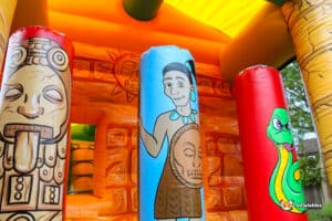 Colourful inflatable jungle obstacle course showcasing a lively design with animals, part of the Aztec Fun Run 1.