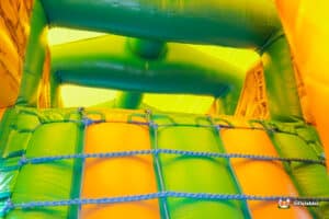 Vibrant inflatable jungle-themed fun run adorned with colourful designs of animals and plants and aztec designed.
