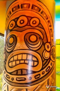 A large mural depicting a face on a pillar, on PVC.