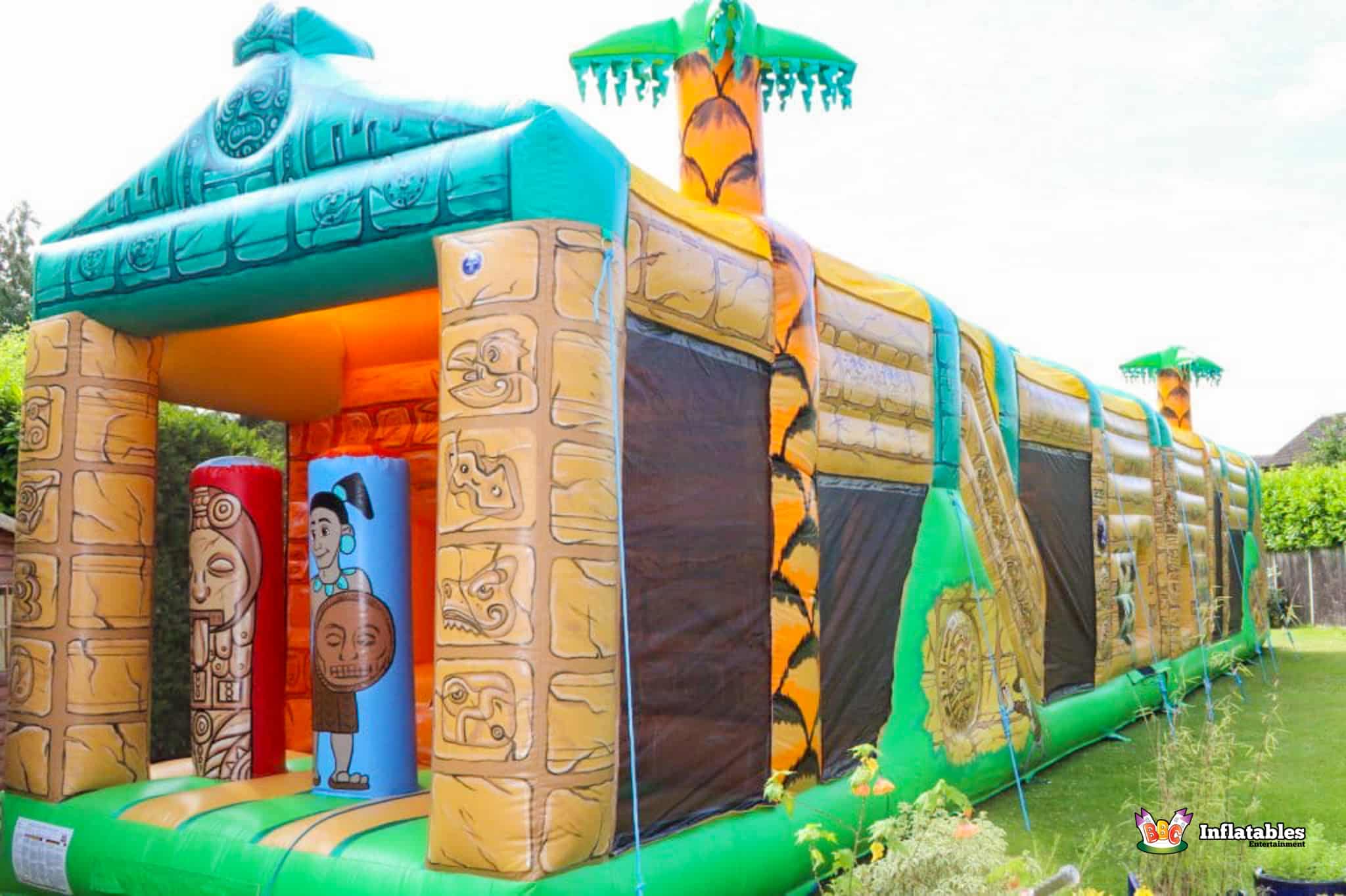 Inflatable jungle-themed Course featuring vibrant colors and designs, labeled as the Aztec Obstacle Course.