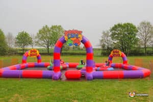 A vibrant scene of inflatable bumper cars on a field, with participants engaged in a lively game.