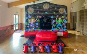 Black and red bouncy castle plasma cars.