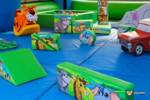 A children's jungle-themed play area featuring a soft play inflatable arena designed for safe and fun play.