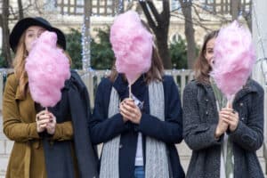 three girls eat candy
