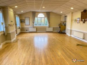 Empty hall space and windows showing low ceilings