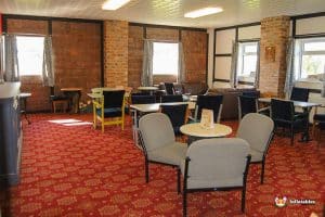Lounge area with tables and chairs.