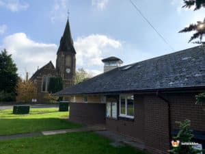 Welland Parish Hall with church in the rear