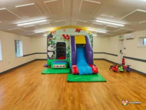 Jungle themed bouncy castle with matching colour plasma cars.
